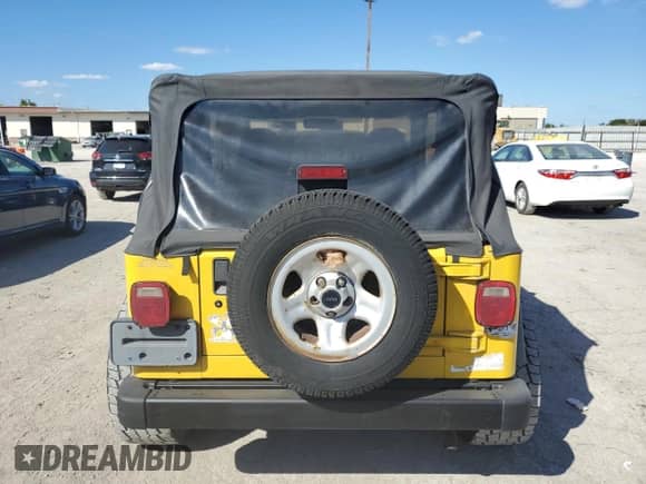 2000 Jeep Wrangler Sport z VIN 1J4FA49S0YP763894, wystawiony jako Copart lot #83925635 z przebiegiem 205 752 mil mil oraz Czysty tytuł • Clean title. Historia ofert i sprzedaży dostępna na DreamBid. Obrazek 6.