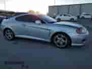 2005 Hyundai Tiburon GT с VIN KMHHN65F05U171038, выставлен на аукционе Copart как лот 87765735 с пробегом 113 129 миль миль и Списание • Salvage title. История ставок и продаж доступна на DreamBid. Изображение 4.