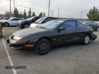 1997 Saturn SC with VIN 1G8ZF1286VZ350275, listed as a Copart auction lot 83010514 with 143,241 mi miles and Salvage title. Bid and sale history available at DreamBid. Image 1.