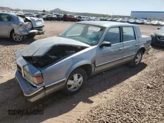 1991 Dodge Dynasty LE с VIN 1B3XC56R9MD115785, выставлен на аукционе Copart как лот 48073715 с пробегом 64 483 миль миль и Списание • Salvage title. История ставок и продаж доступна на DreamBid. Изображение 1.