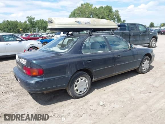 1995 Toyota Camry DX z VIN 4T1SK11E5SU487271, wystawiony jako IAAI lot #42949922 z przebiegiem 288 591 mil mil oraz . Historia ofert i sprzedaży dostępna na DreamBid. Obrazek 4.