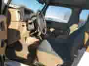 1999 Jeep Wrangler Sahara z VIN 1J4FY49S0XP459376, wystawiony jako Copart lot #86651405 z przebiegiem 150 917 mil mil oraz Szkoda całkowita • Salvage title. Historia ofert i sprzedaży dostępna na DreamBid. Obrazek 7.