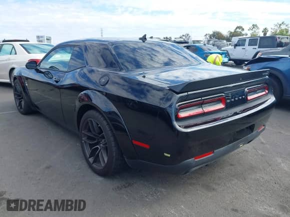 2021 Dodge Challenger R/T Scat Pack Widebody with VIN 2C3CDZFJ7MH677011, listed as a IAAI auction lot 43412091 with 26,783 mi miles and . Bid and sale history available at DreamBid. Image 3.