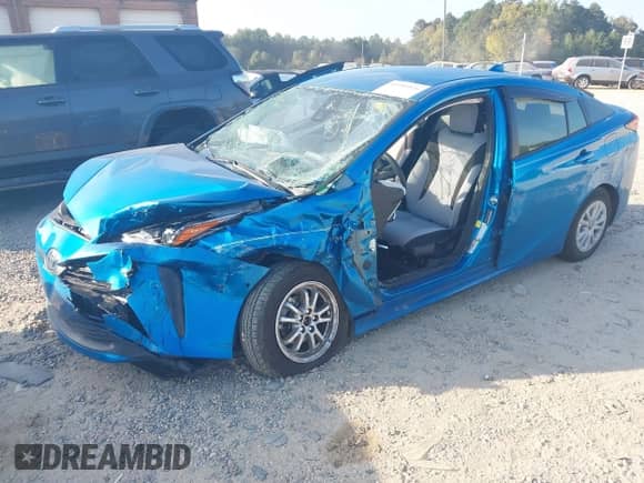 2021 Toyota Prius L Eco with VIN JTDKAMFU1M3136133, listed as a IAAI auction lot 43285926 with 49,911 mi miles and . Bid and sale history available at DreamBid. Image 2.