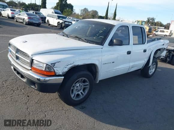 2002 Dodge Dakota SLT with VIN 1B7HL48NX2S518299, listed as a IAAI auction lot 41414659 with 220,943 mi miles and . Bid and sale history available at DreamBid. Image 2.