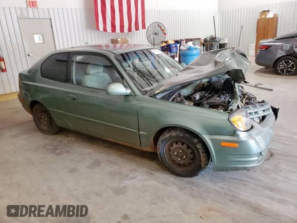 2005 Hyundai Accent GLS z VIN KMHCG35CX5U335467, wystawiony jako Copart lot #61091895 z przebiegiem Nie podano mil oraz Szkoda całkowita • Salvage title. Historia ofert i sprzedaży dostępna na DreamBid. Obrazek 4.