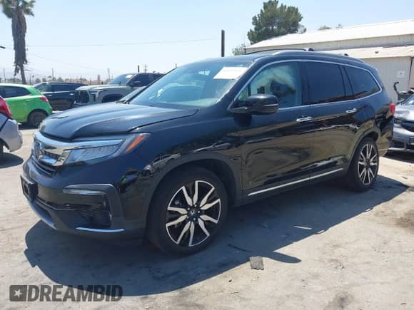 2022 Honda Pilot Touring 8-Passenger with VIN 5FNYF5H94NB004420, listed as a IAAI auction lot 42223140 with 43,210 mi miles and . Bid and sale history available at DreamBid. Image 2.