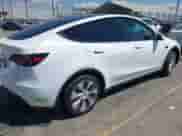 2023 Tesla Model Y Long Range z VIN 7SAYGDEE9PA081036, wystawiony jako IAAI lot #43151161 z przebiegiem 49 637 mil mil oraz . Historia ofert i sprzedaży dostępna na DreamBid. Obrazek 4.