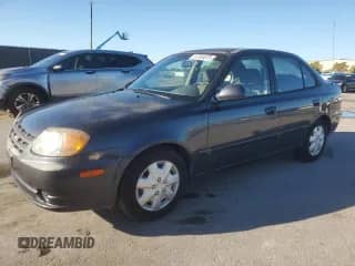 2005 Hyundai Accent GLS z VIN KMHCG45C05U665091, wystawiony jako Copart lot #87264075 z przebiegiem 179 141 mil mil oraz Szkoda całkowita • Salvage title. Historia ofert i sprzedaży dostępna na DreamBid. Obrazek 1.