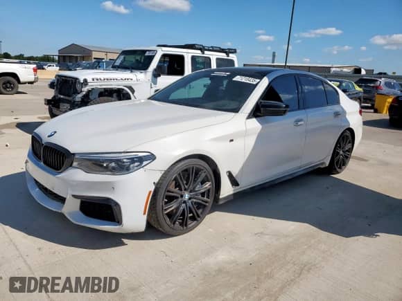 2018 BMW 5 Series M550i xDrive with VIN WBAJB9C54JB034746, listed as a Copart auction lot 71218435 with 128,279 mi miles and Clean title. Bid and sale history available at DreamBid. Image 1.