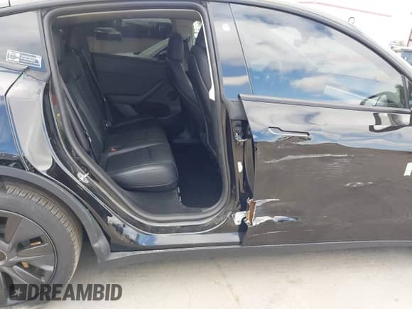 2024 Tesla Model Y with VIN 7SAYGDED8RF156984, listed as a IAAI auction lot 43324819 with 26,941 mi miles and . Bid and sale history available at DreamBid. Image 21.