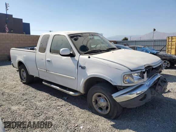 1999 Ford F-150 with VIN 1FTRX18W7XKA55819, listed as a Copart auction lot 64293245 with 301,658 mi miles and Salvage title. Bid and sale history available at DreamBid. Image 4.