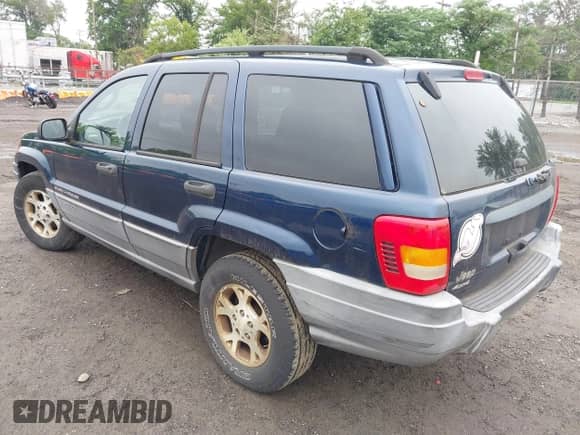 2002 Jeep Grand Cherokee Sport with VIN 1J4GW38S42C166263, listed as a IAAI auction lot 42521707 with 267,842 mi miles and . Bid and sale history available at DreamBid. Image 3.