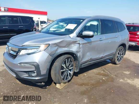 2020 Honda Pilot Touring 7-Passenger z VIN 5FNYF5H65LB025229, wystawiony jako IAAI lot #43149923 z przebiegiem 120 414 mil mil oraz . Historia ofert i sprzedaży dostępna na DreamBid. Obrazek 2.