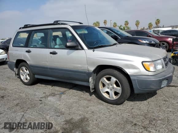 1999 Subaru Forester L with VIN JF1SF6353XH727555, listed as a Copart auction lot 80185275 with 186,950 mi miles and Salvage title. Bid and sale history available at DreamBid. Image 4.