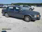 1989 Dodge Dynasty with VIN 1B3BC4632KD615753, listed as a Copart auction lot 64080955 with 54,020 mi miles and Salvage title. Bid and sale history available at DreamBid. Image 4.