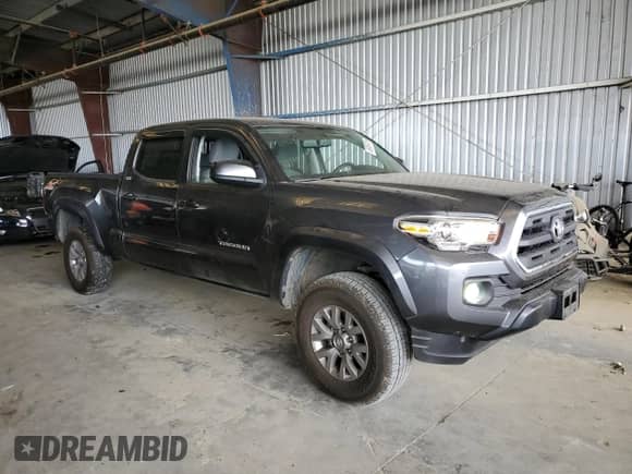 2017 Toyota Tacoma SR5 with VIN 3TMDZ5BNXHM027664, listed as a Copart auction lot 65009735 with 76,227 mi miles and Salvage title. Bid and sale history available at DreamBid. Image 4.