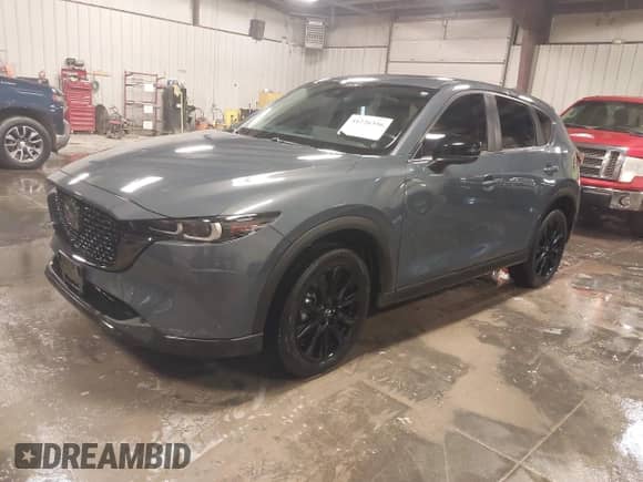 2022 Mazda CX-5 S Carbon Edition z VIN JM3KFBCM3N0527885, wystawiony jako IAAI lot #41226356 z przebiegiem 25 691 mil mil oraz . Historia ofert i sprzedaży dostępna na DreamBid. Obrazek 2.