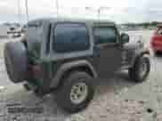 2000 Jeep Wrangler Sport z VIN 1J4FA49S7YP741858, wystawiony jako Copart lot #59058075 z przebiegiem 223 876 mil mil oraz Czysty tytuł • Clean title. Historia ofert i sprzedaży dostępna na DreamBid. Obrazek 3.