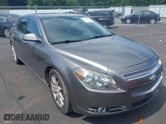 2012 Chevrolet Malibu LTZ z VIN 1G1ZG5E77CF164975, wystawiony jako IAAI lot #42513864 z przebiegiem 195 299 mil mil oraz . Historia ofert i sprzedaży dostępna na DreamBid. Obrazek 1.