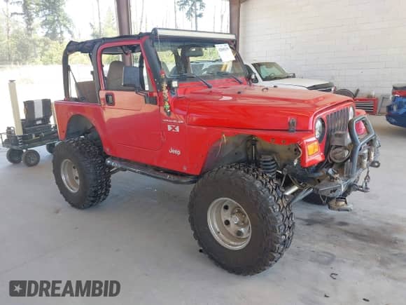 2002 Jeep Wrangler X z VIN 1J4FA39S62P775680, wystawiony jako IAAI lot #42808299 z przebiegiem 118 886 mil mil oraz . Historia ofert i sprzedaży dostępna na DreamBid. Obrazek 1.