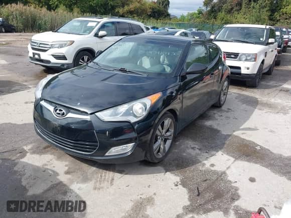 2012 Hyundai Veloster w/Gray Int z VIN KMHTC6AD6CU049429, wystawiony jako IAAI lot #43410430 z przebiegiem 153 050 mil mil oraz . Historia ofert i sprzedaży dostępna na DreamBid. Obrazek 2.