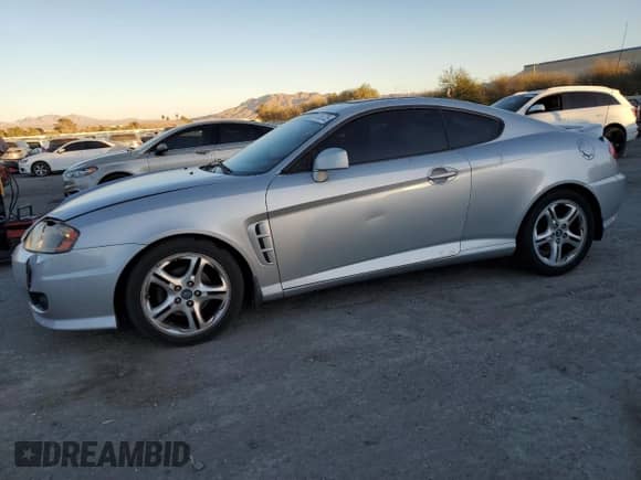 2005 Hyundai Tiburon GT с VIN KMHHN65F05U171038, выставлен на аукционе Copart как лот 87765735 с пробегом 113 129 миль миль и Списание • Salvage title. История ставок и продаж доступна на DreamBid. Изображение 1.