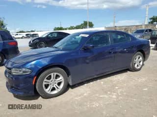 2015 Dodge Charger SE with VIN 2C3CDXBG9FH878958, listed as a Copart auction lot 82213205 with 86,582 mi miles and Salvage title. Bid and sale history available at DreamBid. Image 1.