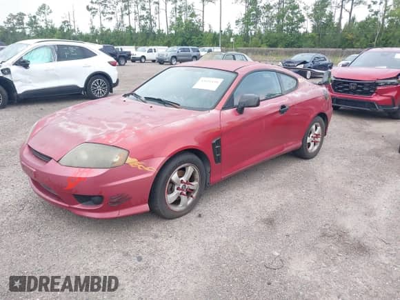 2005 Hyundai Tiburon GS z VIN KMHHM65D35U168510, wystawiony jako IAAI lot #42691110 z przebiegiem 128 386 mil mil oraz . Historia ofert i sprzedaży dostępna na DreamBid. Obrazek 2.