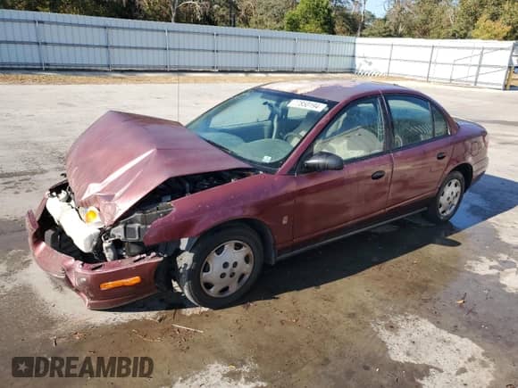 2001 Saturn SL with VIN 1G8ZH54841Z290618, listed as a Copart auction lot 77850194 with 128,083 mi miles and Salvage title. Bid and sale history available at DreamBid. Image 1.