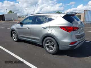 2018 Hyundai Santa Fe 2.4L z VIN 5NMZU3LBXJH098272, wystawiony jako IAAI lot #43375252 z przebiegiem 96 576 mil mil oraz . Historia ofert i sprzedaży dostępna na DreamBid. Obrazek 3.