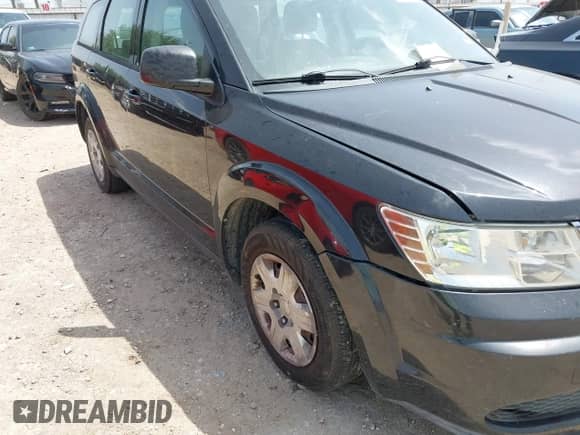 2012 Dodge Journey SE z VIN 3C4PDCAB5CT275973, wystawiony jako IAAI lot #42631803 z przebiegiem 120 440 mil mil oraz . Historia ofert i sprzedaży dostępna na DreamBid. Obrazek 6.