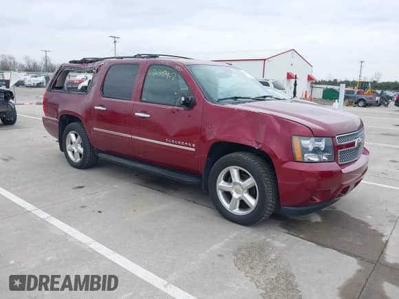 2009 Chevrolet Suburban LTZ z VIN 1GNFK36309J105434, wystawiony jako IAAI lot #42062907 z przebiegiem 132 674 mil mil oraz . Historia ofert i sprzedaży dostępna na DreamBid. Obrazek 1.