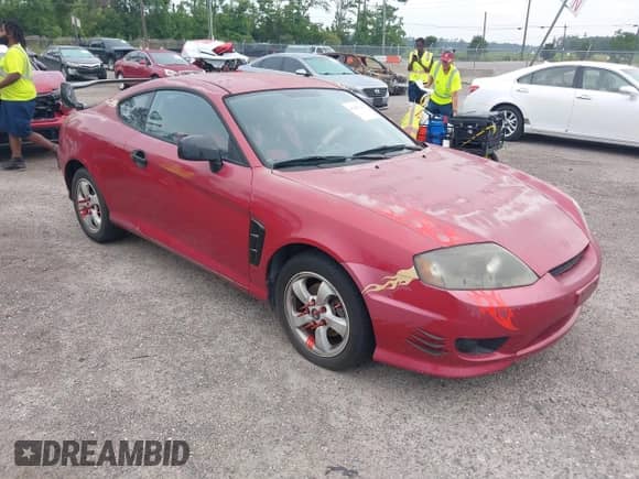 2005 Hyundai Tiburon GS z VIN KMHHM65D35U168510, wystawiony jako IAAI lot #42691110 z przebiegiem 128 386 mil mil oraz . Historia ofert i sprzedaży dostępna na DreamBid. Obrazek 1.