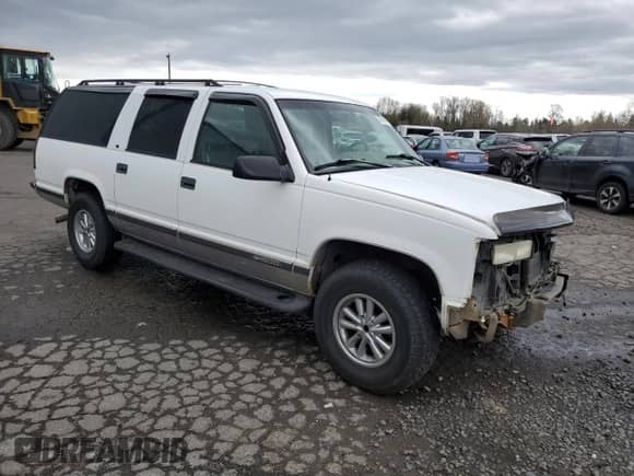 1996 Chevrolet Suburban with VIN 1GNFK16R5TJ381317, listed as a Copart auction lot 50214885 with 2,534,495 mi miles and Salvage title. Bid and sale history available at DreamBid. Image 4.
