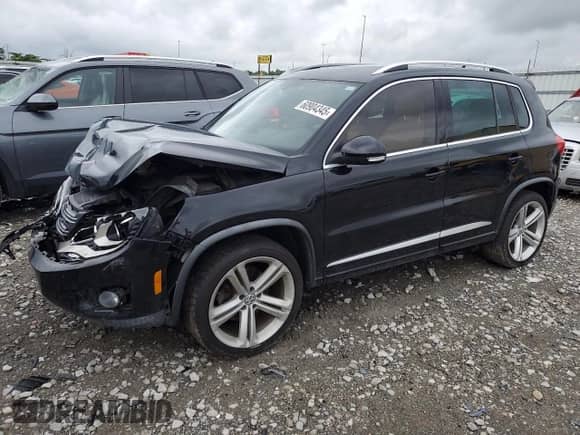 2014 Volkswagen Tiguan SEL with VIN WVGAV3AX7EW101796, listed as a Copart auction lot 60904345 with 97,652 mi miles and Salvage title. Bid and sale history available at DreamBid. Image 1.