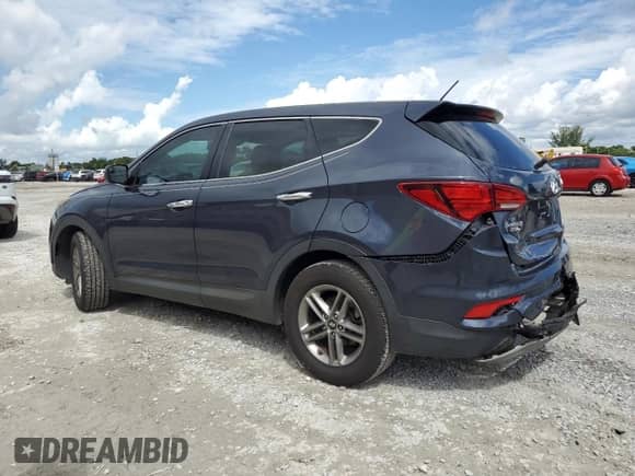 2018 Hyundai Santa Fe 2.4L z VIN 5NMZTDLB8JH093127, wystawiony jako Copart lot #81774275 z przebiegiem 104 339 mil mil oraz Szkoda całkowita • Salvage title. Historia ofert i sprzedaży dostępna na DreamBid. Obrazek 2.