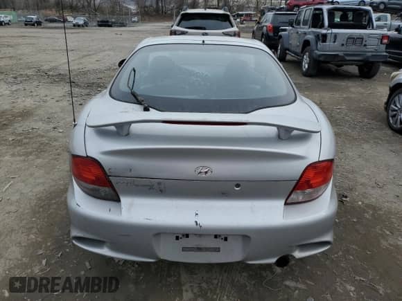 2001 Hyundai Tiburon с VIN KMHJG35F31U224416, выставлен на аукционе Copart как лот 83243684 с пробегом 59 473 миль миль и Списание • Salvage title. История ставок и продаж доступна на DreamBid. Изображение 6.
