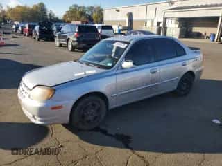 2005 Hyundai Accent GLS with VIN KMHCG45C15U635114, listed as a Copart auction lot 87037075 with 64,796 mi miles and Salvage title. Bid and sale history available at DreamBid. Image 1.