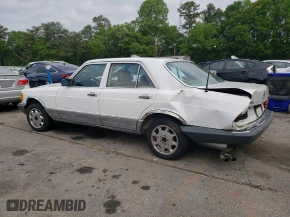 1985 Mercedes-Benz 380 with VIN WDBCA32C8FA127549, listed as a Copart auction lot 54406985 with 167,688 mi miles and Salvage title. Bid and sale history available at DreamBid. Image 2.
