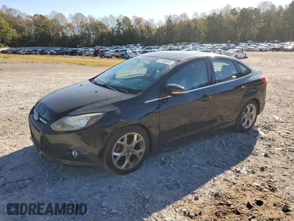 2014 Ford Focus Titanium with VIN 1FADP3J25EL379233, listed as a Copart auction lot 87100875 with 128,688 mi miles and Salvage title. Bid and sale history available at DreamBid. Image 1.
