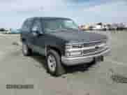 1998 Chevrolet Tahoe z VIN 3GNEK18R8WG130659, wystawiony jako Copart lot #81615845 z przebiegiem 308 784 mil mil oraz Szkoda całkowita • Salvage title. Historia ofert i sprzedaży dostępna na DreamBid. Obrazek 14.