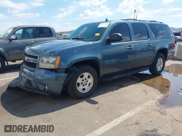 2009 Chevrolet Suburban 2LT z VIN 1GNFC26059R226166, wystawiony jako IAAI lot #43264407 z przebiegiem 131 813 mil mil oraz . Historia ofert i sprzedaży dostępna na DreamBid. Obrazek 2.