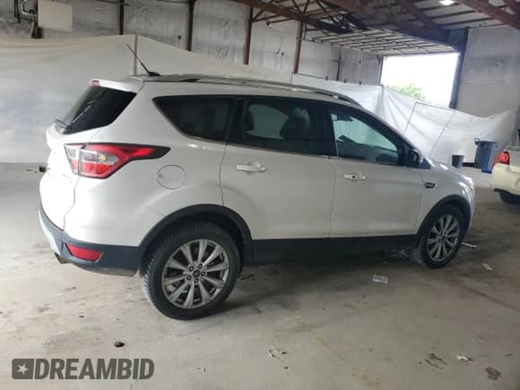 2017 Ford Escape Titanium with VIN 1FMCU0J95HUB40074, listed as a Copart auction lot 64801755 with 97,794 mi miles and Salvage title. Bid and sale history available at DreamBid. Image 3.