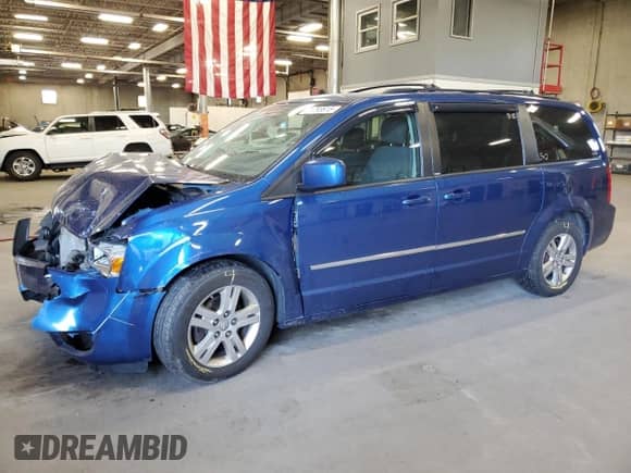 2010 Dodge Grand Caravan Crew with VIN 2D4RN6DX1AR455209, listed as a Copart auction lot 71793615 with 243,904 mi miles and Salvage title. Bid and sale history available at DreamBid. Image 1.