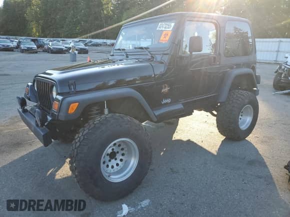 1997 Jeep Wrangler Sahara with VIN 1J4FY49SXVP486730, listed as a Copart auction lot 82473255 with 143,015 mi miles and Salvage title. Bid and sale history available at DreamBid. Image 1.