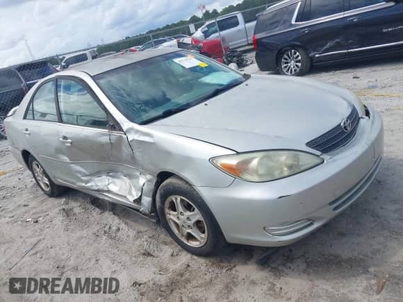 2002 Toyota Camry LE z VIN JTDBE32K320094291, wystawiony jako IAAI lot #42970747 z przebiegiem 198 294 mil mil oraz . Historia ofert i sprzedaży dostępna na DreamBid. Obrazek 1.