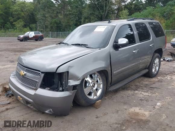 2012 Chevrolet Tahoe LTZ with VIN 1GNSCCE00CR189878, listed as a IAAI auction lot 43297739 with 129,423 mi miles and . Bid and sale history available at DreamBid. Image 2.
