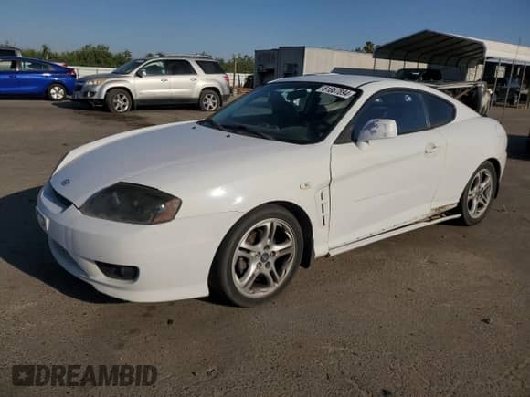 2006 Hyundai Tiburon GT z VIN KMHHN65F46U191990, wystawiony jako Copart lot #61887894 z przebiegiem 252 384 mil mil oraz Szkoda całkowita • Salvage title. Historia ofert i sprzedaży dostępna na DreamBid. Obrazek 1.