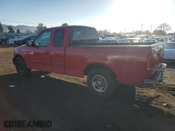 2001 Ford F-150 with VIN 2FTZX17281CA43267, listed as a Copart auction lot 85808284 with 324,614 mi miles and Salvage title. Bid and sale history available at DreamBid. Image 2.
